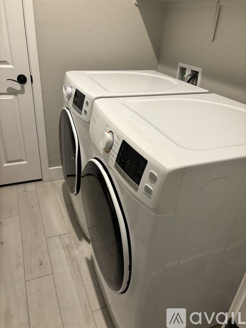 Two front loading washing machines in a laundry room.