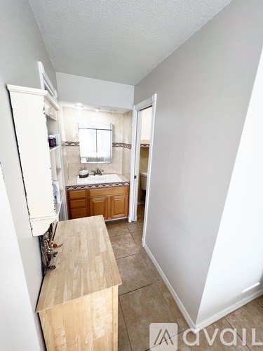 A small, empty room with a wooden counter and a window.