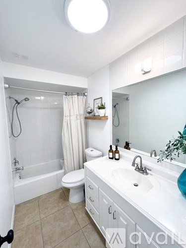 A bathroom with a white sink, toilet, and bathtub.