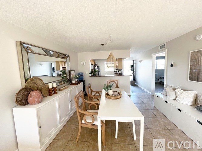 A dining area with a white table and chairs.