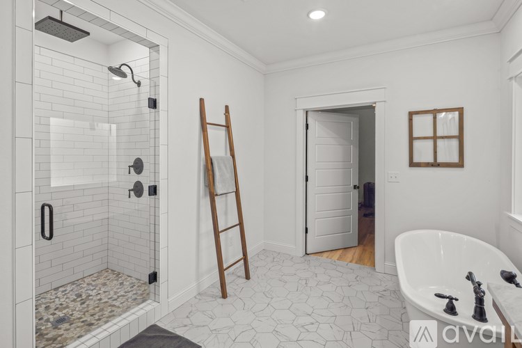 A white bathroom with a walk-in shower and a bathtub.