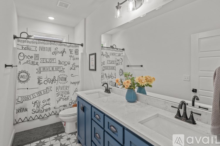 A bathroom with a shower curtain that has various phrases written on it.