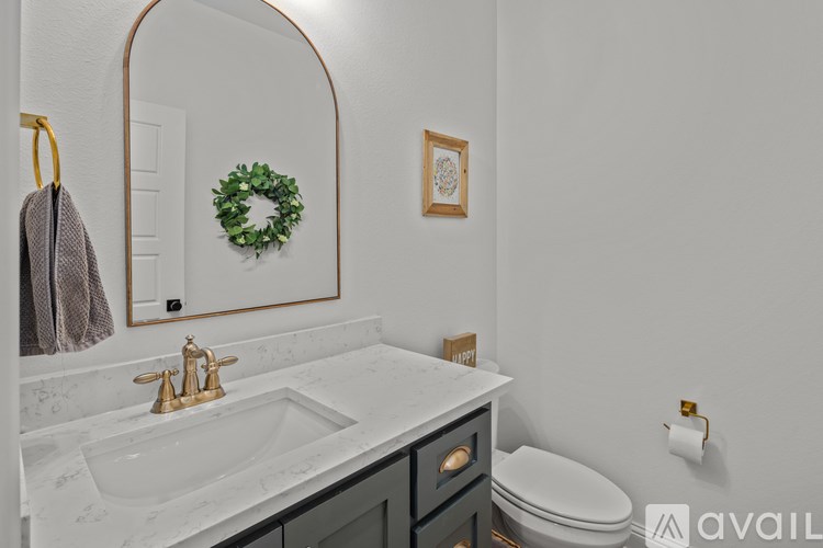 A bathroom with a marble countertop and a toilet.