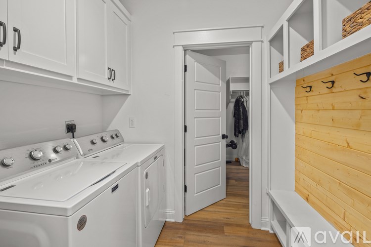 A white stove and oven in a kitchen with wooden walls.