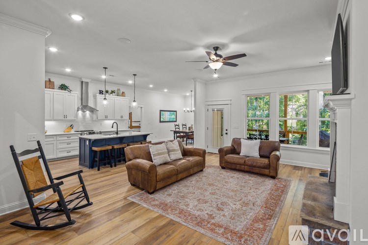 A living room with a rocking chair and a couch.