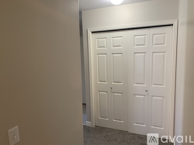 A white door in a room with a light on.