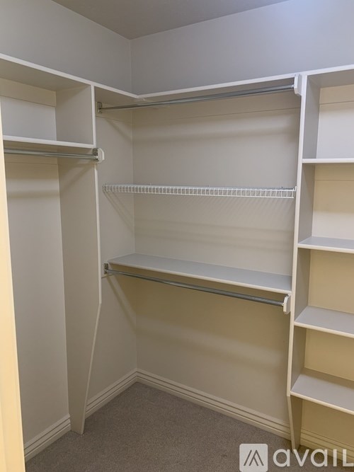 A white closet with shelves and hanging space.