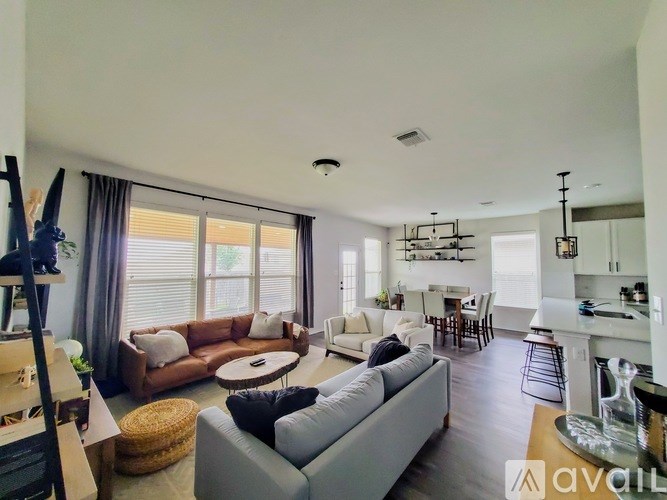A living room with a grey couch and a wooden coffee table.
