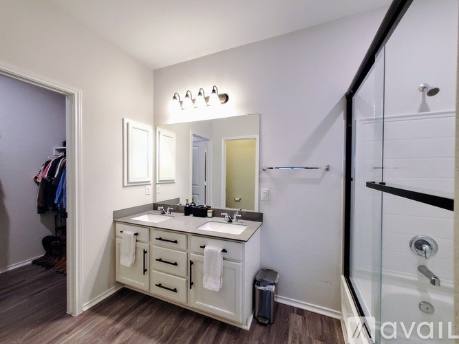 A bathroom with a vanity and a mirror above it.