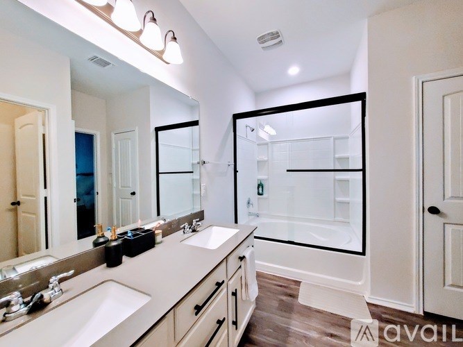 A bathroom with two sinks and a large mirror.