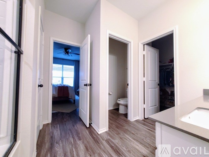 A room with a bed, a toilet, and a sink.