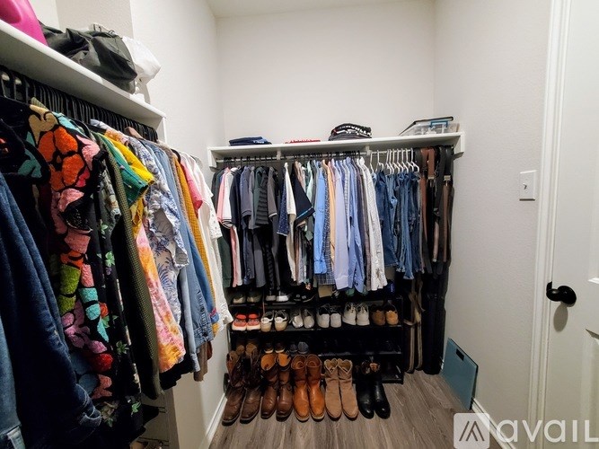 A well-organized walk-in closet with neatly arranged clothes and shoes.