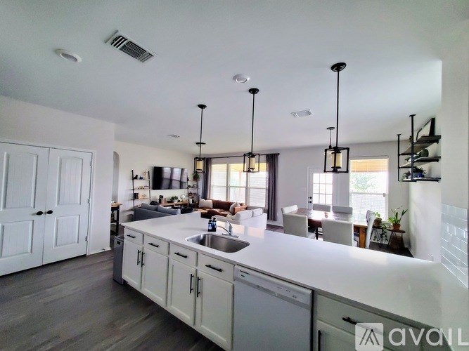 A modern kitchen with white cabinets and a large island.