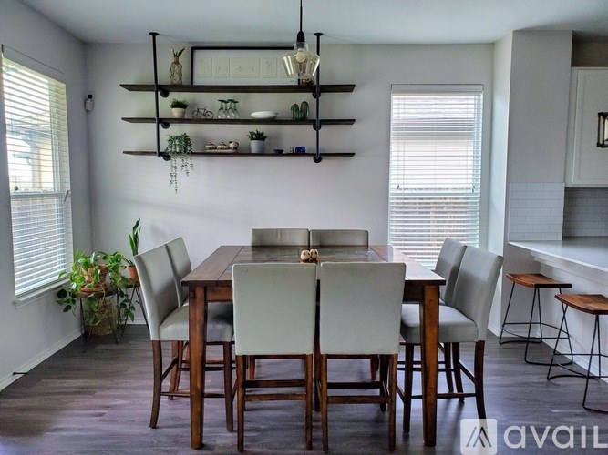 A dining room with a wooden table and chairs.