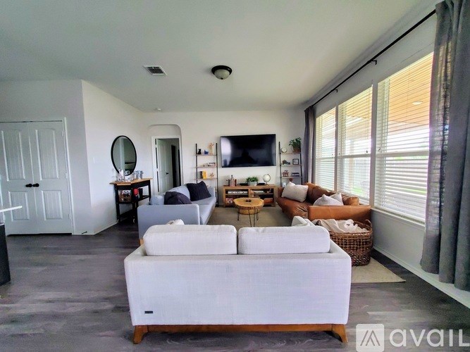 A living room with a white sofa and a television.