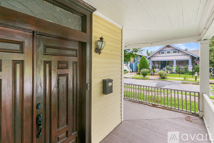 A wooden door with a glass window above it.