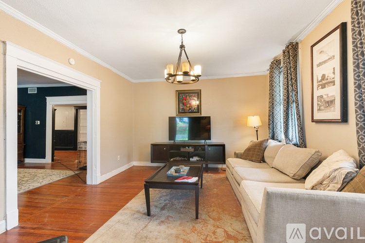 A living room with a couch, coffee table, and television.