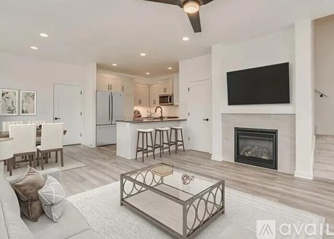 A modern living room with a fireplace and a television mounted above it.