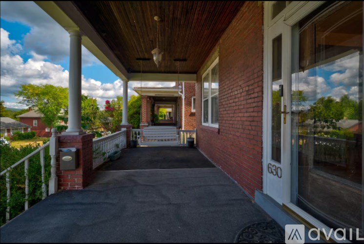 A porch with a black tarp on it.