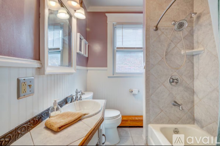 A bathroom with a towel on the counter and a toilet in the corner.