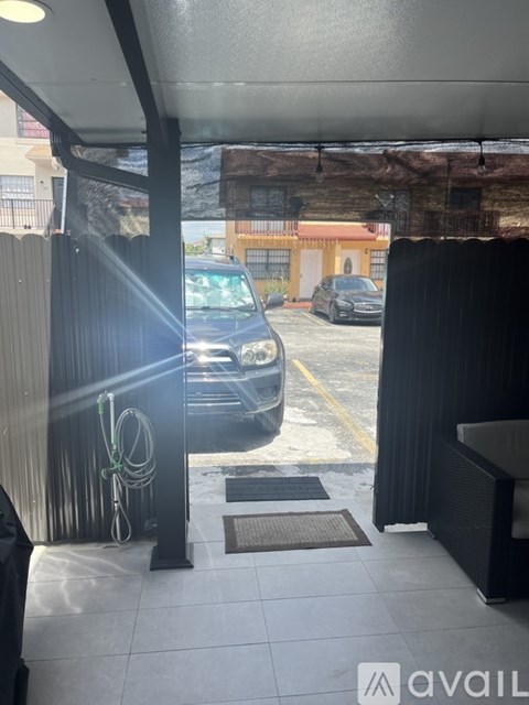 A black car is parked in a parking lot.