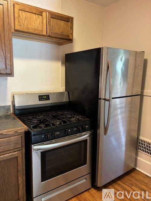A kitchen with a black refrigerator, stove, and oven.