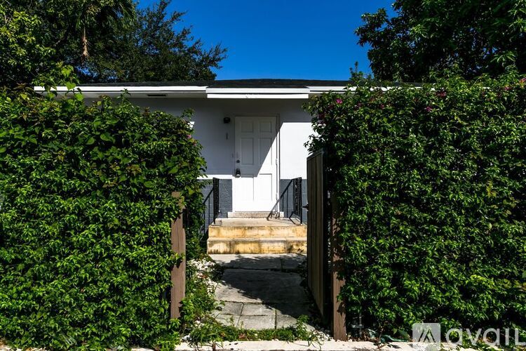 A white house with a white door and a small porch.