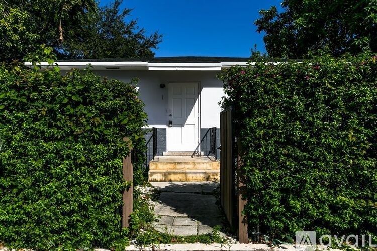 A white house with a white door and a small porch.