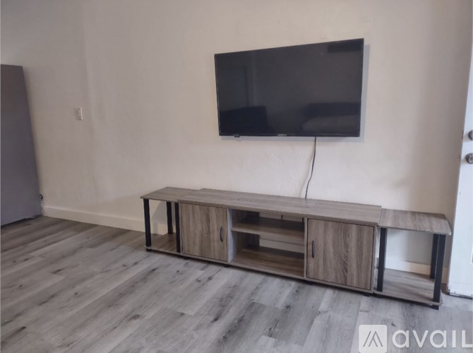 A modern tv stand with a flat screen tv mounted on the wall.