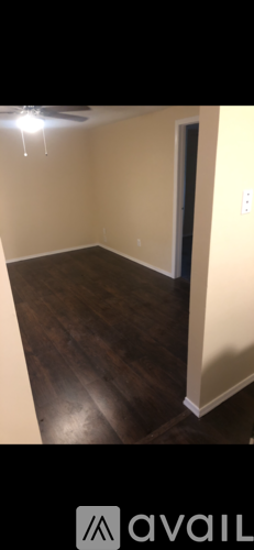 A room with wooden flooring and a white door.
