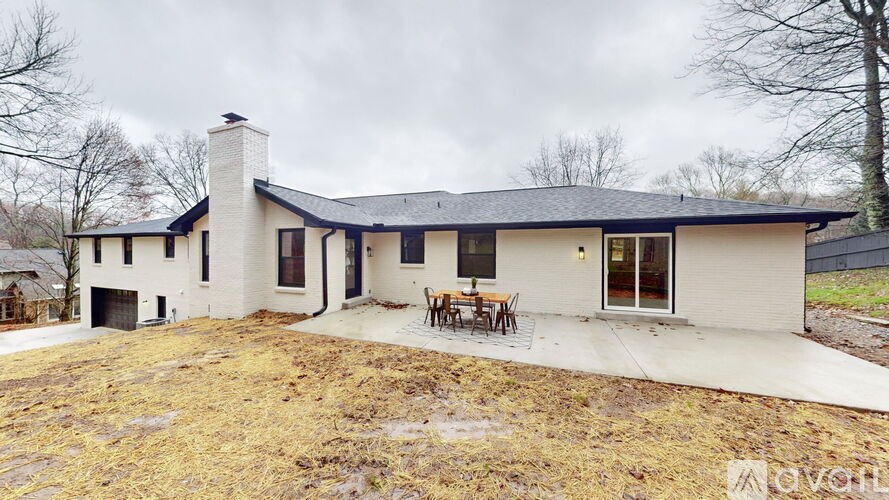 A modern house with a black roof and white walls.