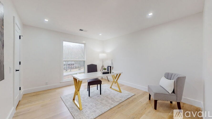 A living room with a grey sofa, a yellow chair, and a grey armchair.