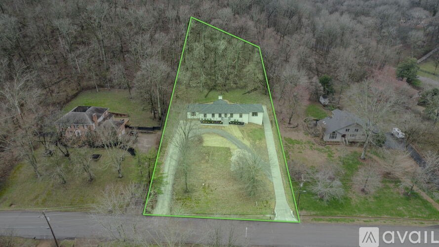 An aerial view of a property with a green outlined area.