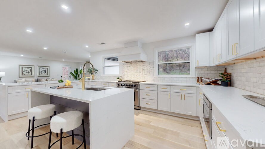 A modern kitchen with white cabinets and a central island.
