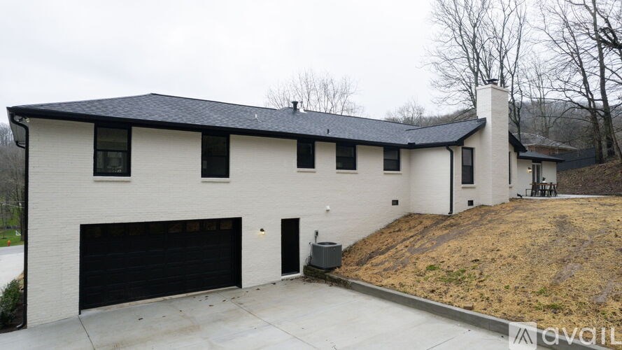 A two-story house with a black garage door.