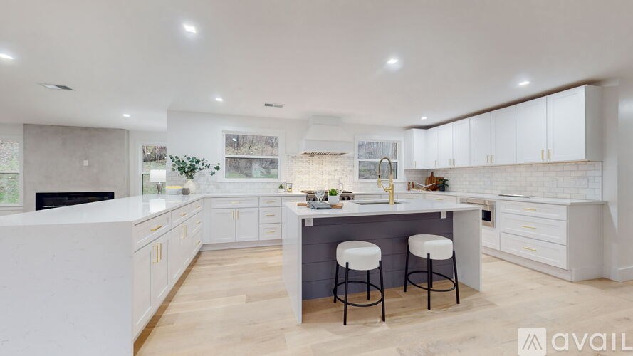 A modern kitchen with white cabinets and a central island.