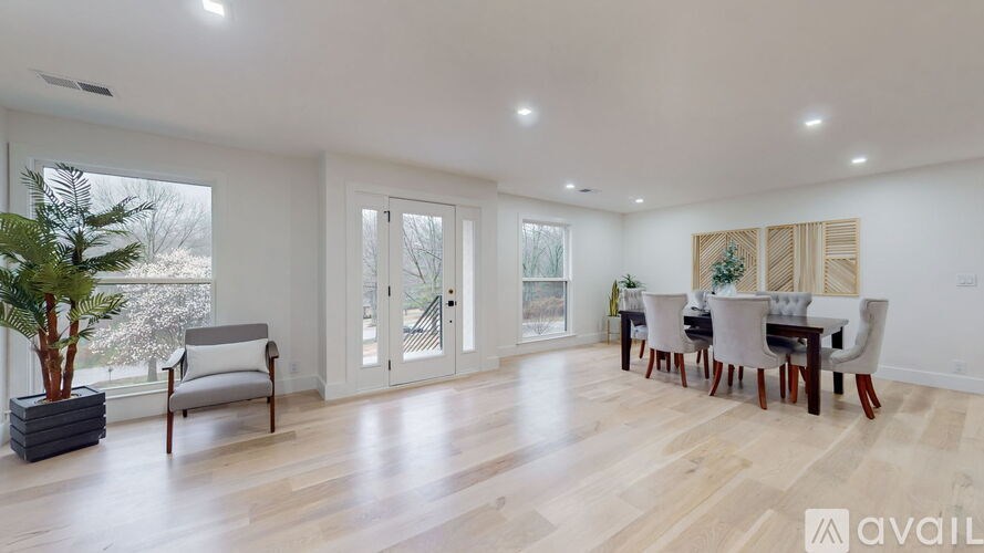 A living room with a dining table and chairs.