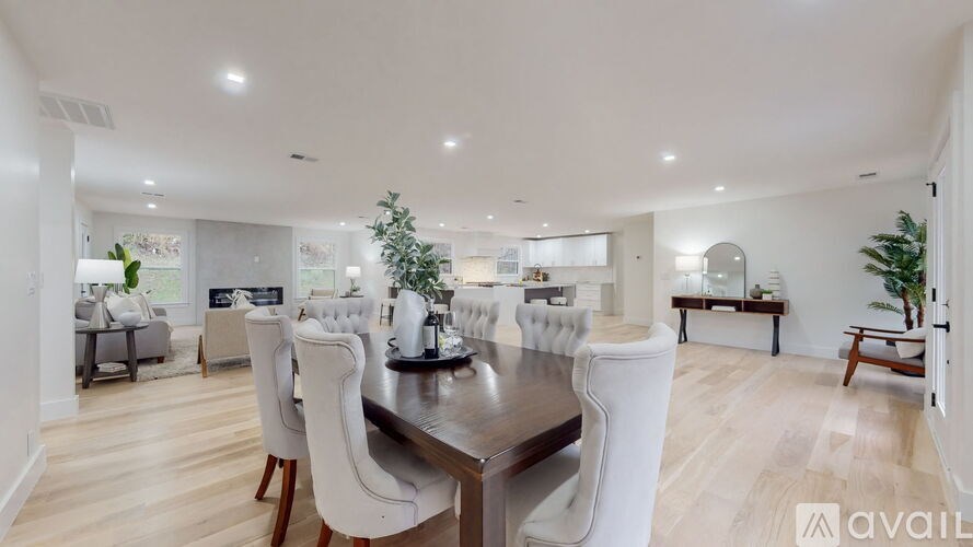 A modern dining room with a large table and chairs.