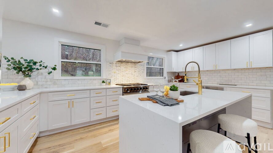 A modern kitchen with white cabinets and a central island.