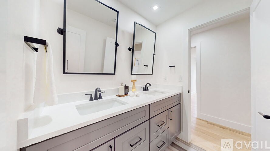 A bathroom with a sink, mirror, and cabinets.