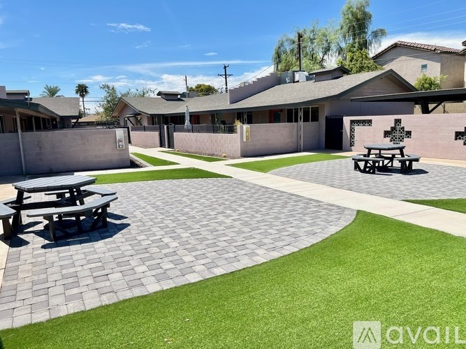 A sunny day at the outdoor picnic area with a stone pathway leading to a picnic table.