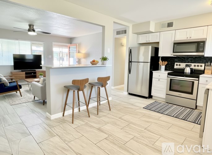 A kitchen with white cabinets and a black stove top.