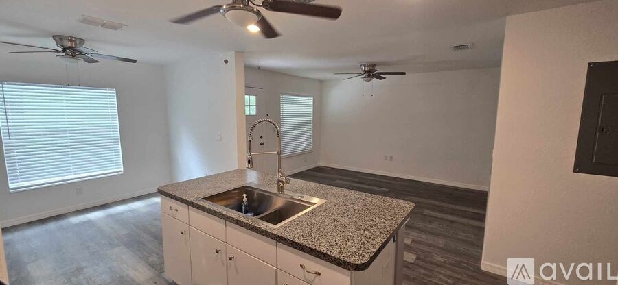 A kitchen with a granite countertop and a sink.