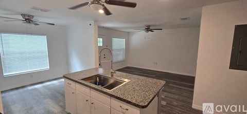 A kitchen with a granite countertop and a sink.