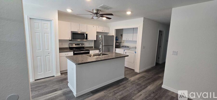 A kitchen with a granite countertop and a refrigerator.