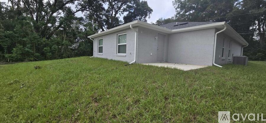 A house with a white exterior is available for sale.