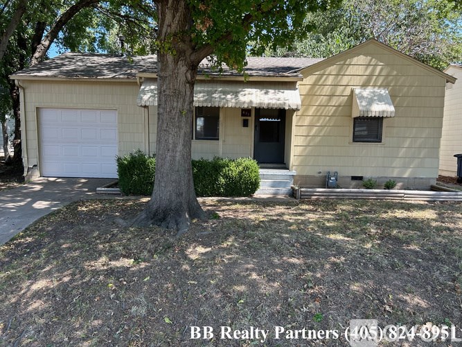 A house with a tree in front of it.