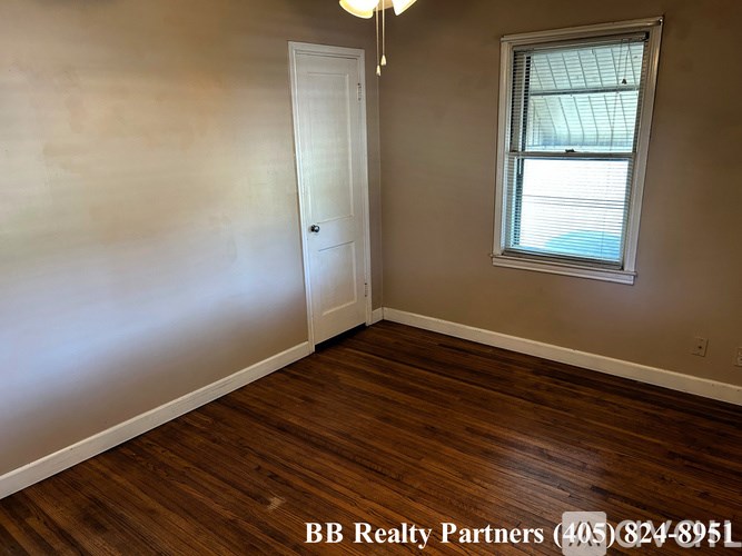 A room with a door, a window, and a light fixture.
