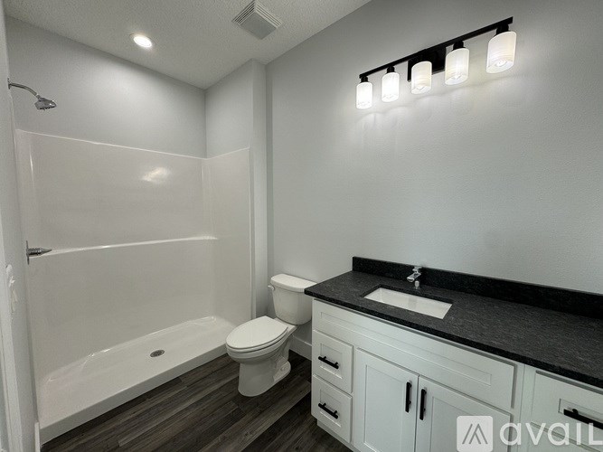 A bathroom with a white tub, toilet, and sink.