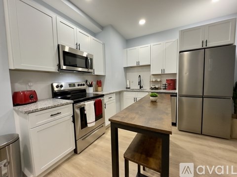 A kitchen with white cabinets and stainless steel appliances.